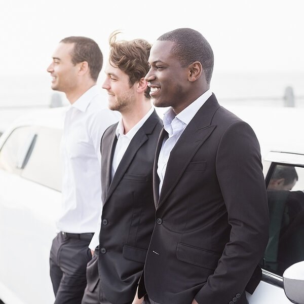 three men leaning beside the car